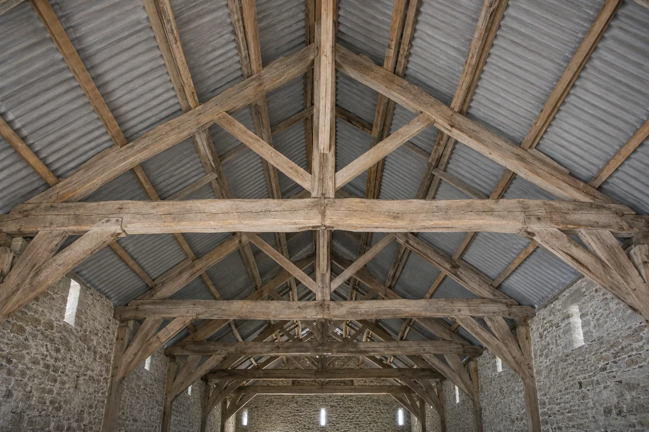 Vue intérieure de fermes en bois sous la couverture d’un bâtiment agricole